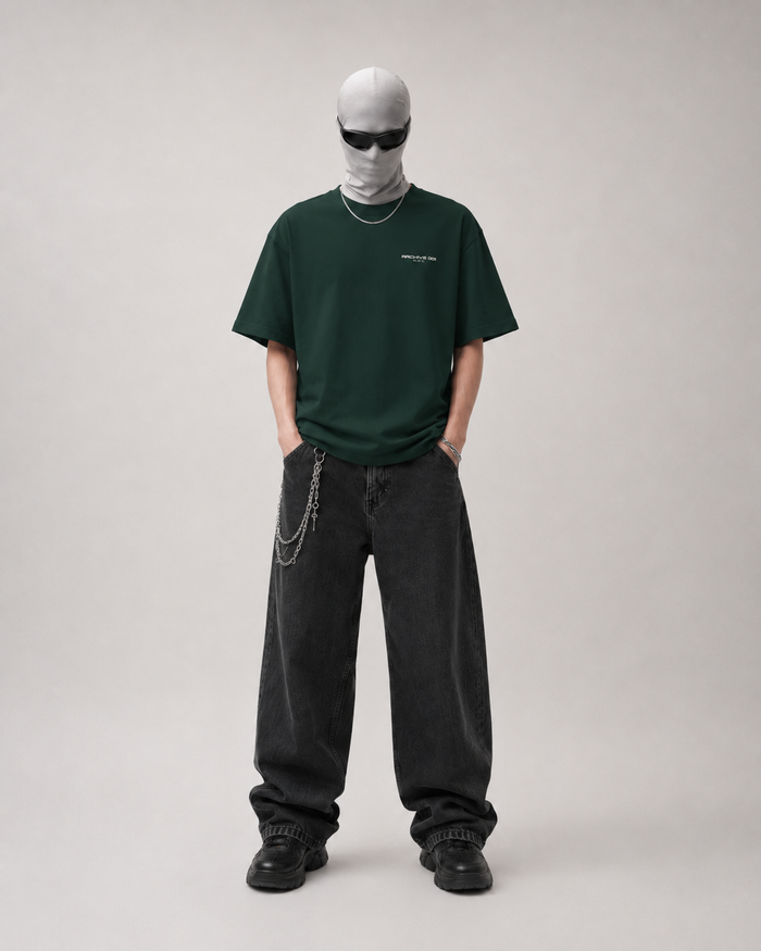 Person wearing a green t-shirt and black pants on a plain background